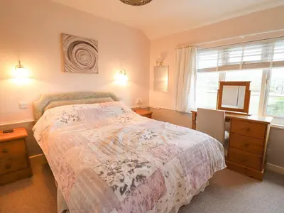 a bedroom with a bed and a window at Morlyn Guest House Apartment in Harlech
