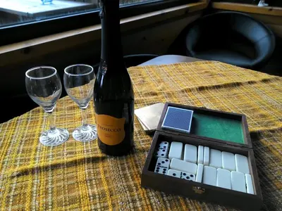 a bottle of wine and two glasses on a table at Shifty Chicken Shack in Trawsfynydd