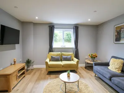 a living room with a couch and a tv at Talarddu Cottage in Builth Wells
