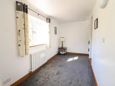 an empty room with a window at Tan Y Capel in Llanbrynmair