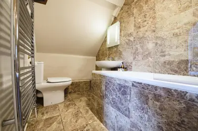 a bathroom with a toilet and a sink and a tub at RHUBARB at Drapers Hall in Shrewsbury