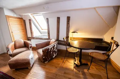 a living room with a table and chairs at RHUBARB at Drapers Hall in Shrewsbury
