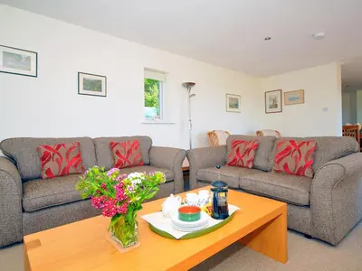 a living room with two couches and a coffee table at Tir Gafr in Harlech