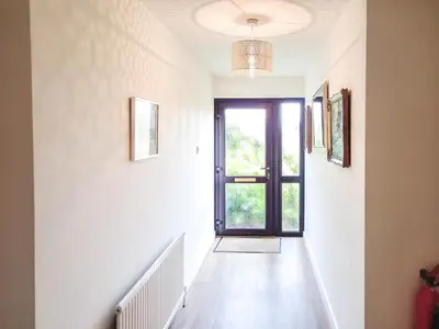 an empty hallway with a door and a window at Gors Y Gader in Llanelltyd