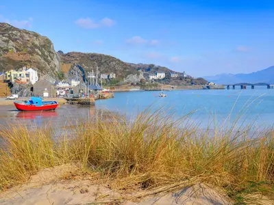 a body of water with a red boat in it at Gors Y Gader in Llanelltyd