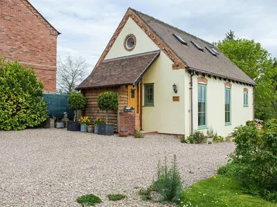 a small house with a gravel driveway at Little Bank Cottage in Lane to Richards Castle