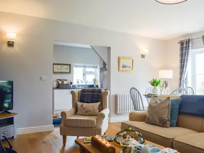 a living room with a couch and a tv at Little Bank Cottage in Lane to Richards Castle