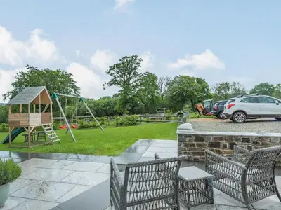 a park with a playground and a car parked at The Old Cow Shed At Ty Hir in Cilcennin