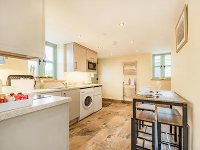 a kitchen with a sink and a dishwasher at The Old Cow Shed At Ty Hir in Cilcennin