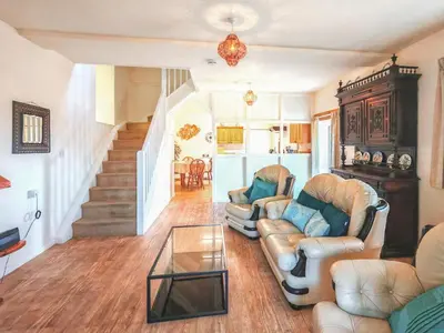 a living room with two couches and a glass table at Arthfan in Llanelltyd