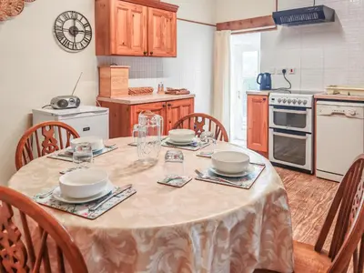 a kitchen with a table with plates and bowls on it at Arthfan in Llanelltyd