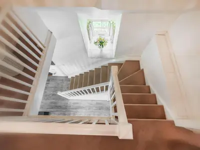 a staircase in a house with a vaulted ceiling at Arthfan in Llanelltyd
