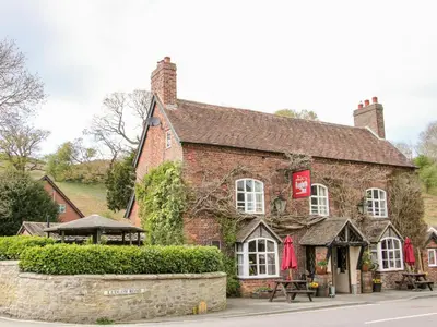 an old brick building with a restaurant in front of it at Gerry's Place in Church Stretton