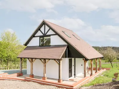 a small white house with a brown roof at Gerry's Place in Church Stretton