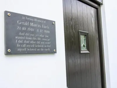 a sign on a wall next to a door at Gerry's Place in Church Stretton