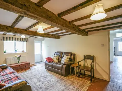 a living room with a couch and a chair at Garth Ucha in Llanyblodwel