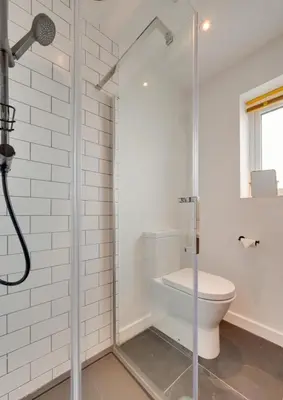 a bathroom with a shower and a toilet at 3 Bed in Barmouth oc-wah701 in Barmouth