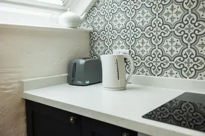 a kitchen counter with a toaster and a coffee mug at The Coach House in Llangollen