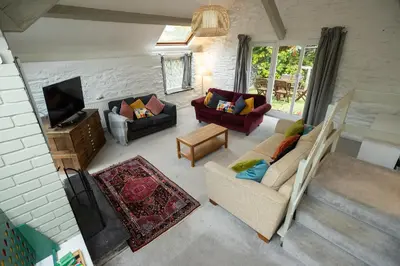 a living room with two couches and a tv at The Coach House in Llangollen
