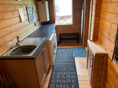 a kitchen with a sink and a counter top at Luxury 3 bedroom, 3 bathroom lodge with hot tub in Llanbedr