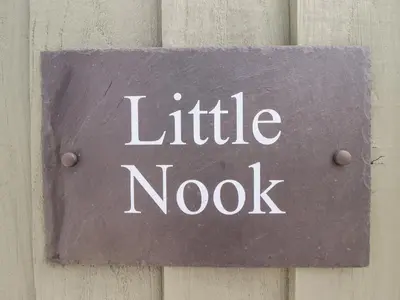 a sign that reads little nook on a wall at Little Nook in Corwen