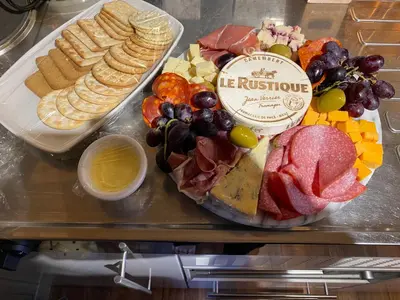 a table topped with different types of meats and cheese at Romantic Croft with Private Hot Tub in Shrewsbury