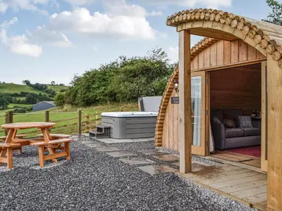 a wooden gazebo with a couch and a table at Valley View - Uk34178 in Cilycwm