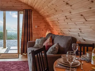 a living room with a couch and a table with wine glasses at Valley View - Uk34178 in Cilycwm