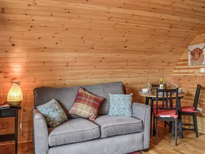 a couch in a living room with a wooden wall at Valley View - Uk34178 in Cilycwm