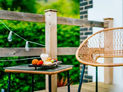 a plate of fruit on a table on a patio at Cwtch Enrico - Uk39064 in Scyborycoed