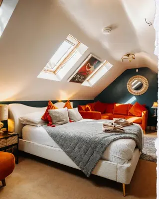 a attic bedroom with a bed and skylights at Boutique Shrewsbury Suites in Shrewsbury