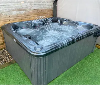 a hot tub with water coming out of it at Stunning Pet-Friendly Home with Hot Tub less than one minute walk from Barmouth Beach in Barmouth
