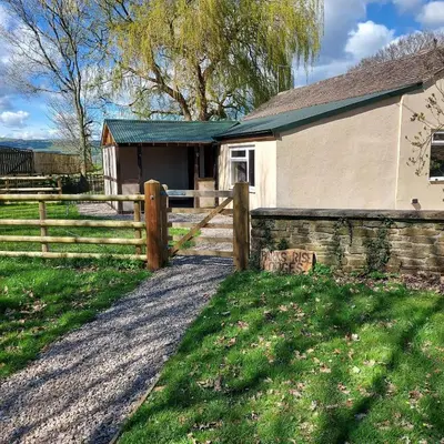 a house with a fence next to a field at 1 Bed Lodge-Sleeps 4-Pet Friendly-Free Parking in Hereford
