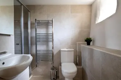 a bathroom with a toilet and a sink and a shower at Snowdonia Holiday Cottage in Bala