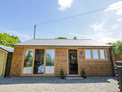 a log cabin with glass doors and windows at Fairfield in Ludlow