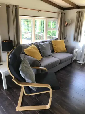 a living room with a couch and a chair at Pheasant Lodge in Builth Wells