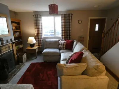 a living room with a couch and a chair at Shepherds Cottage in Shrewsbury