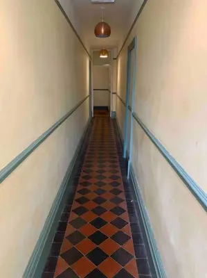 a hallway with a checkered floor in a building at The Nest, central Ludlow one bed apartment in Ludlow