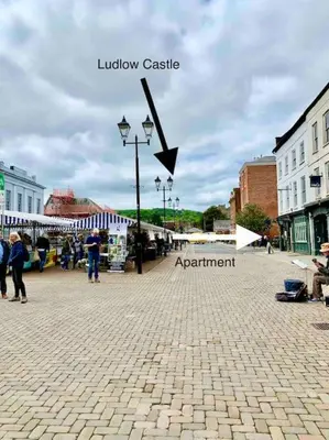 a street in a town with a sign that reads library castle at The Nest, central Ludlow one bed apartment in Ludlow