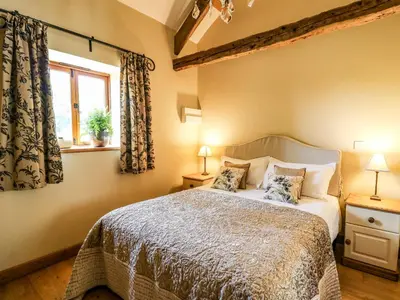 a bedroom with a bed and a window at Golwg Las in Llanwrda