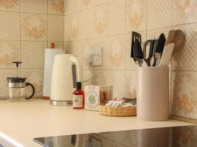 a kitchen counter with a counter top with utensils at The Stables in Shrewsbury