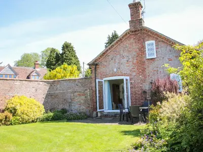 an external view of a brick house with a yard at The Stables in Shrewsbury