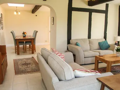 a living room with two couches and a table at The Stables in Shrewsbury