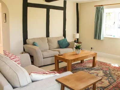 a living room with a couch and a table at The Stables in Shrewsbury