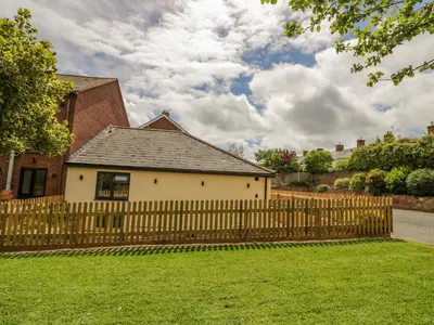 a wooden fence in front of a house at 2 The Villa in Ludlow