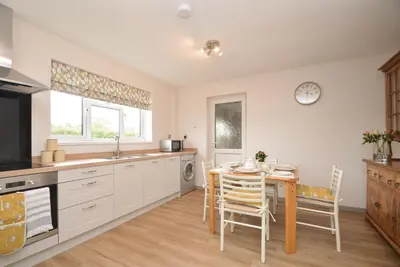 a kitchen with a table and a dining room at Berwyn View in Welshpool