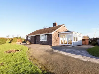 a brick house with a large driveway at Berwyn View in Welshpool