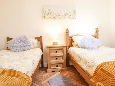 a bedroom with two beds and a night stand at Varley Villa in Newtown