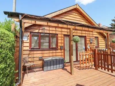 a cabin with a grill on a wooden deck at Varley Villa in Newtown
