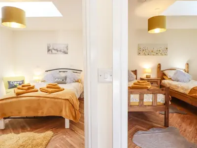 a bedroom with two beds and a table at Varley Villa in Newtown